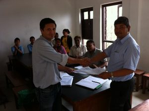 COMMITTED executive director and Dolagiri School Principal sign and exchange agreement on June 11, 2013.