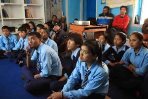 Students and community members listening to a presentation on Fish farming.