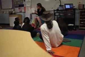 Kristine reads to her student before I make my presentation.