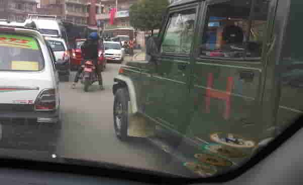 4. Red car followed by a motorcyle & army jeep 09.56.29