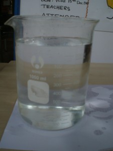 coin under beaker - with water side view